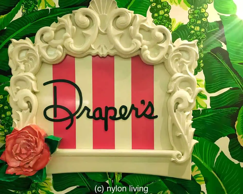 The Drapers Restaurant sign at the Greenbrier Resort adds a pop of color to the Brazilliance wallpaper