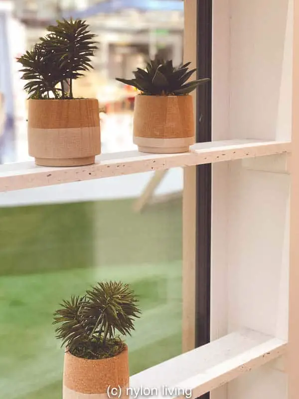The window ledges on this prefab backyard studio are used for holding small succulents. 