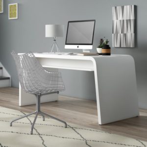 curved desk with computer and chair and rug