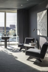 clear work desk and chair in front of a window with a city view