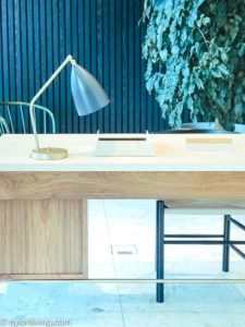 white and oak writing desk and lamp