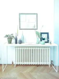 white writing desk over a radiator