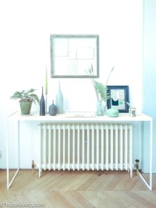 white writing desk over a radiator