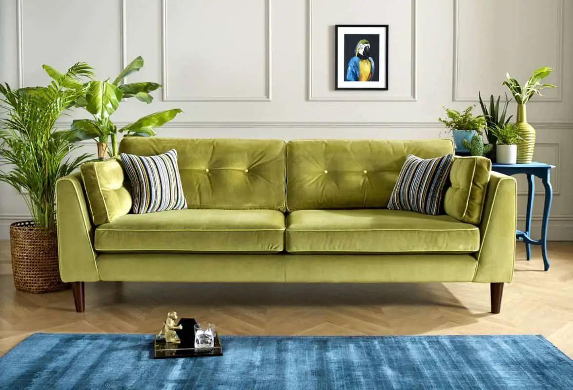 lime green sofa, blue rug and a traditionally painted off white room.