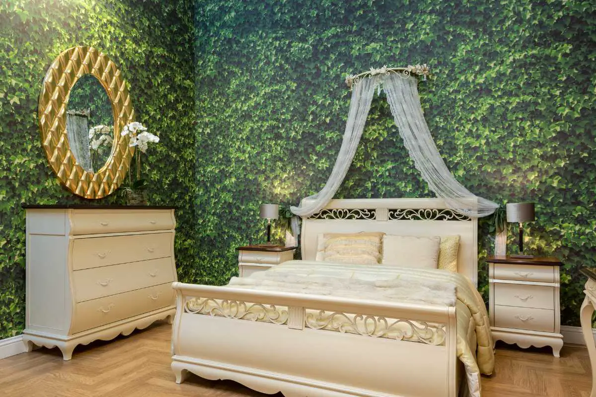 green forest walls surrounding a white canopy bed in a bedroom